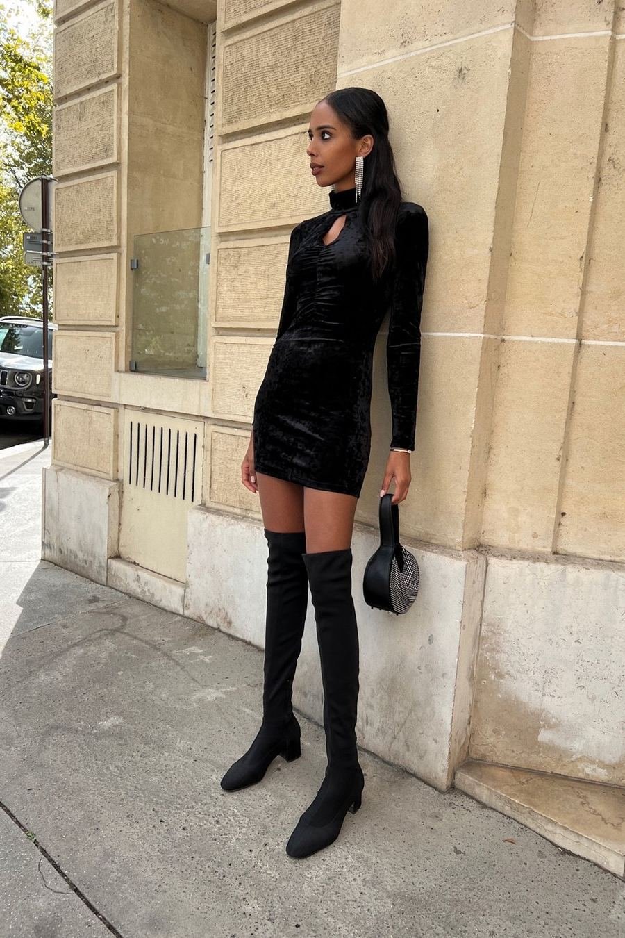 Black velvet mini dress with over-the-knee boots