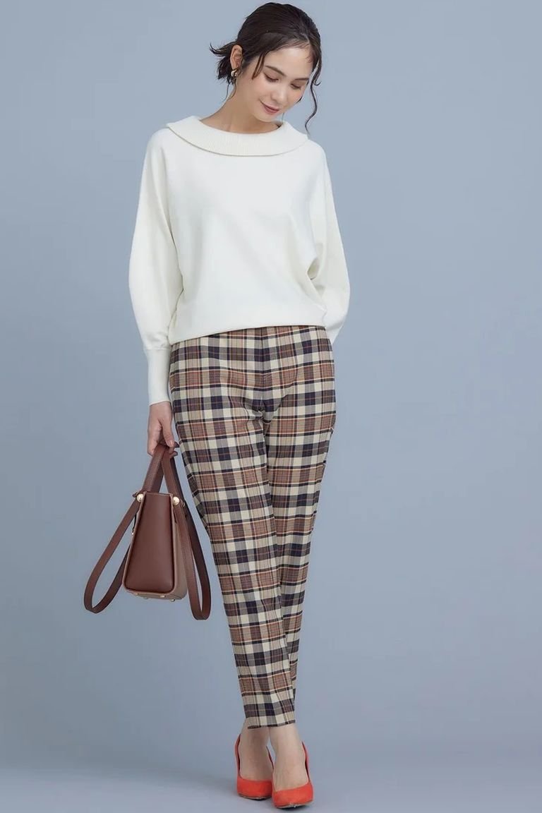 Cream knit sweater with plaid trousers, an office-ready plaid winter outfit for women