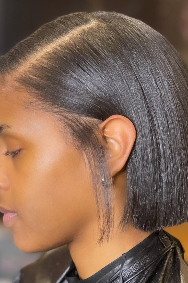 Side-parted jaw length bob with asymmetric volume and movement