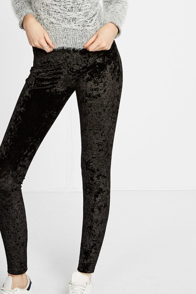 Black velvet leggings with oversized cream sweater and sneakers