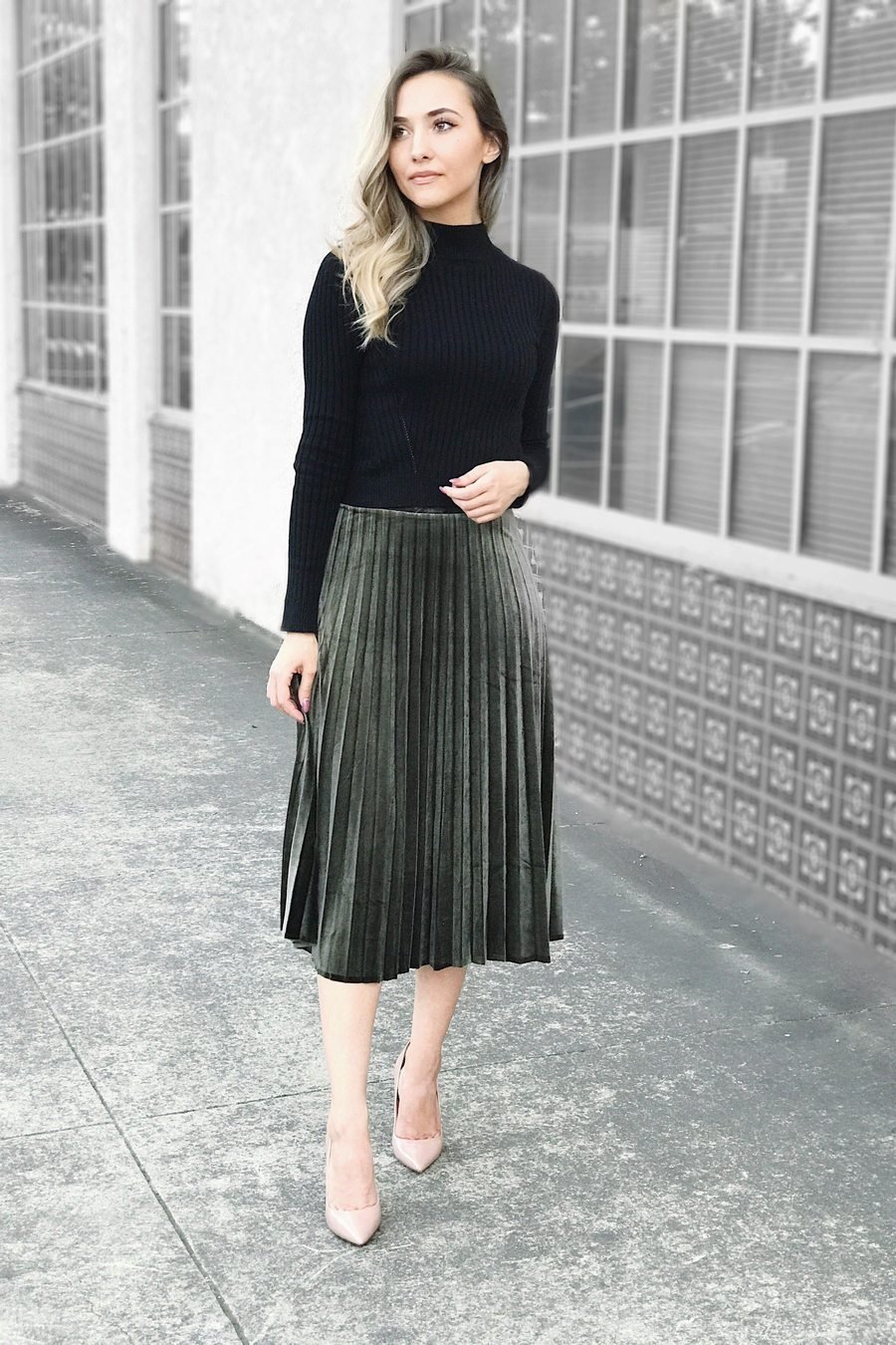 Pleated forest-green velvet midi skirt with black turtleneck