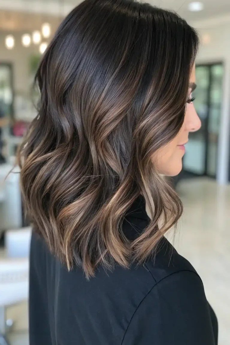 Brunette jaw length cut with balayage dimension where the light hits the jaw