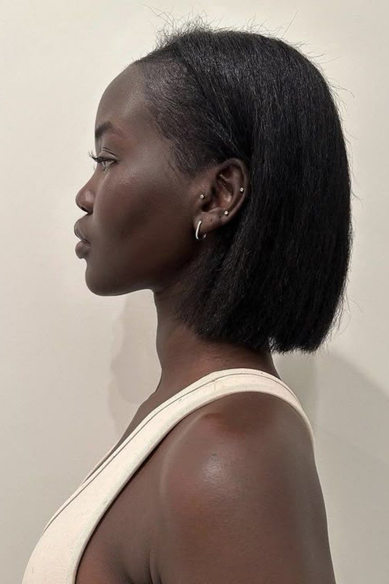 Short coily natural haircut shaped with intention at jaw length