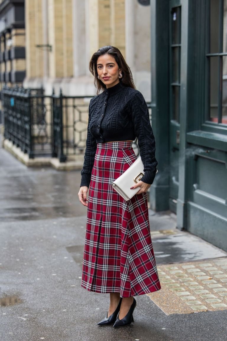 Tartan wrap midi skirt with a black sweater, an elegant plaid winter outfit for dinner dates
