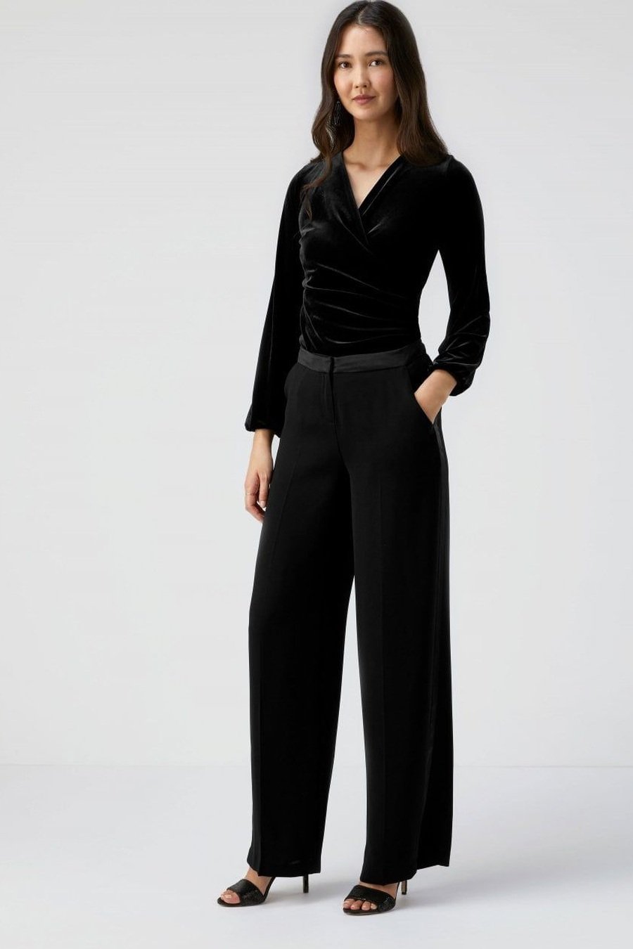 Black velvet wrap blouse with black tailored pants
