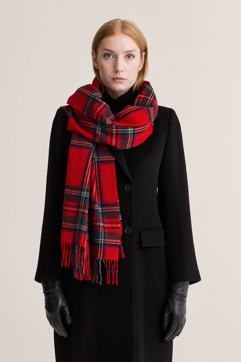 Red plaid scarf with a black coat and boots, a chic plaid winter outfit for date night