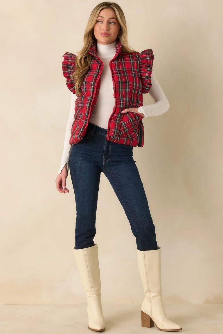 Plaid puffer vest over a turtleneck with jeans, a sporty plaid winter outfit for travel