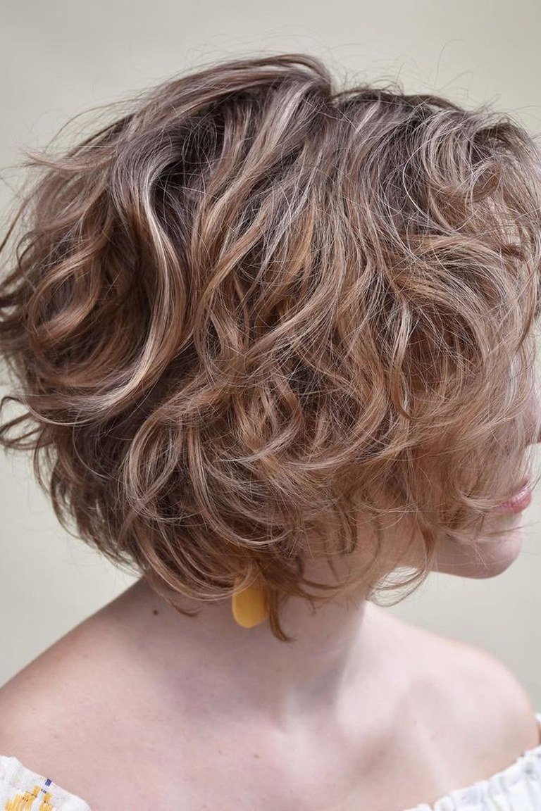 Wavy bob at the jaw-to-lob grow-out stage, styled without the awkward phase