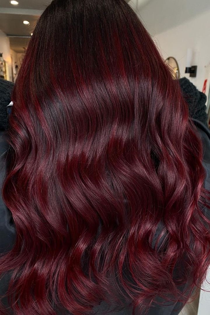 Long wavy merlot wine-red hair with glossy finish