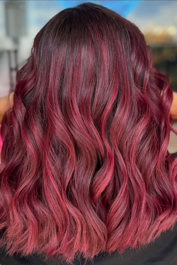 Medium-length rosewood burgundy hair, muted brown-red shade