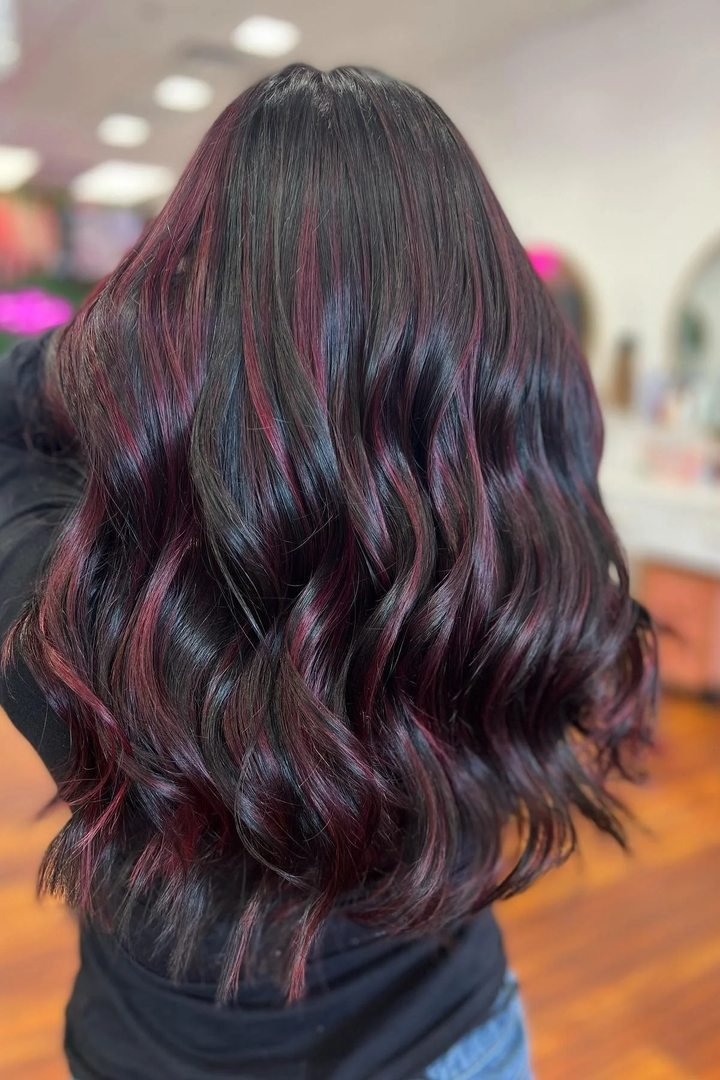 Burgundy ribbon highlights woven through dark hair