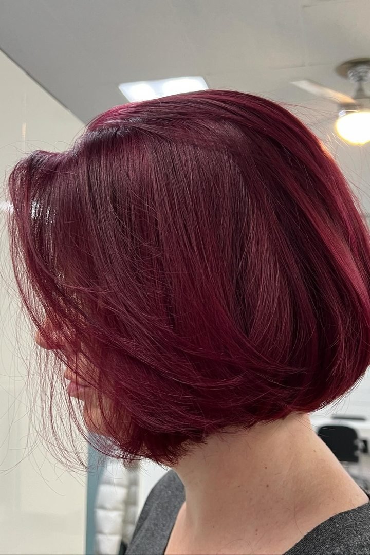 Burgundy bob haircut, deep wine-red on a classic bob