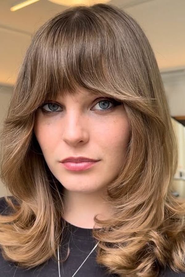Medium layered blowout with a soft wispy fringe and curved ends