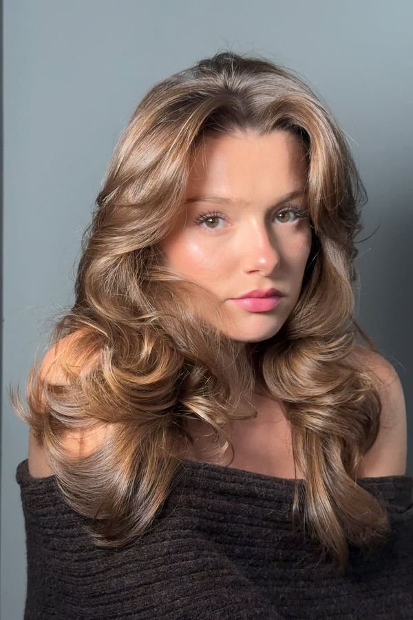 Soft wavy blowout adding visible volume to fine medium-length hair