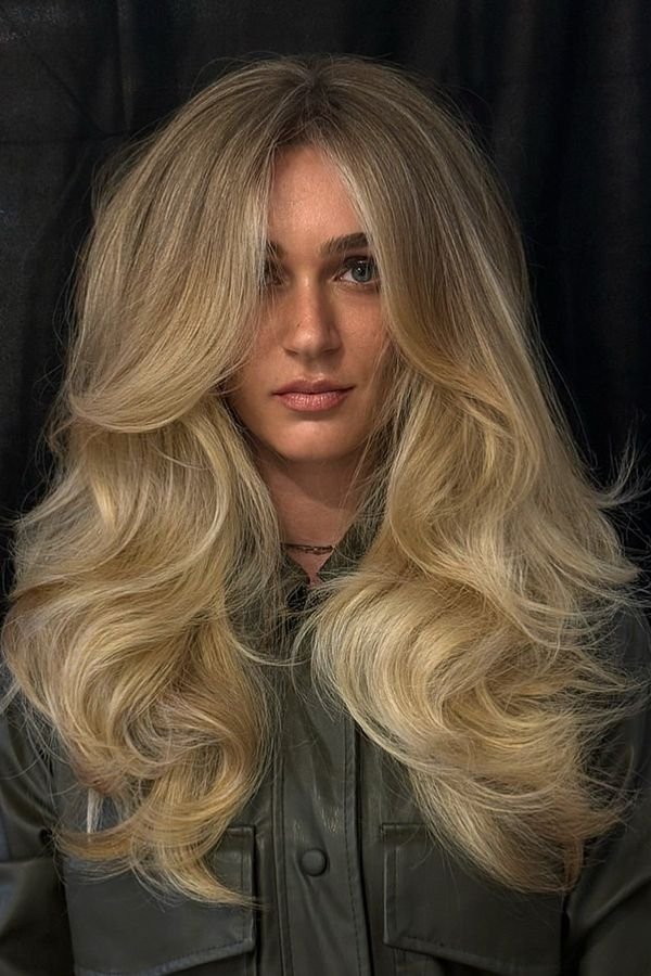Understated old-money blowout in soft blonde waves, front view