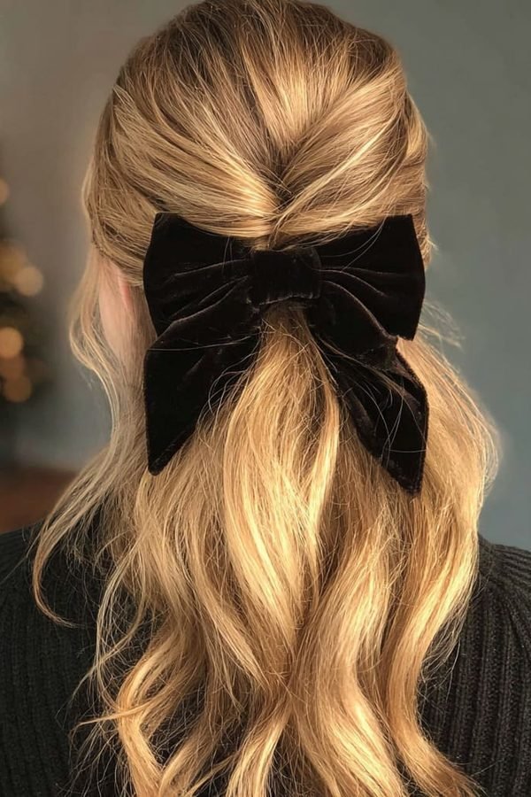 Velvet bow hairstyles in a half-up style on blonde hair