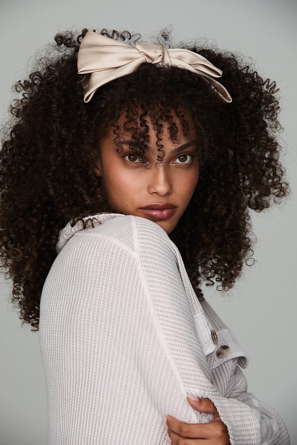 Bow headband worn on natural curly hair