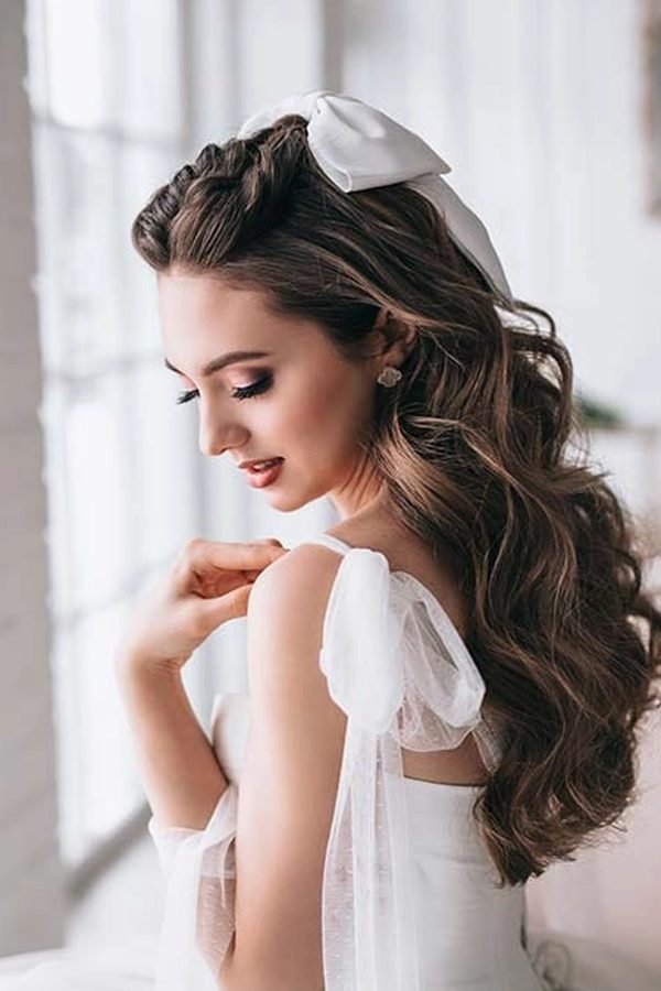 Bridal updo with a white bow