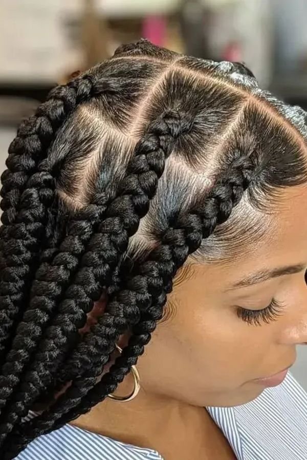 Close-up of jumbo box braids showing large clean square parts