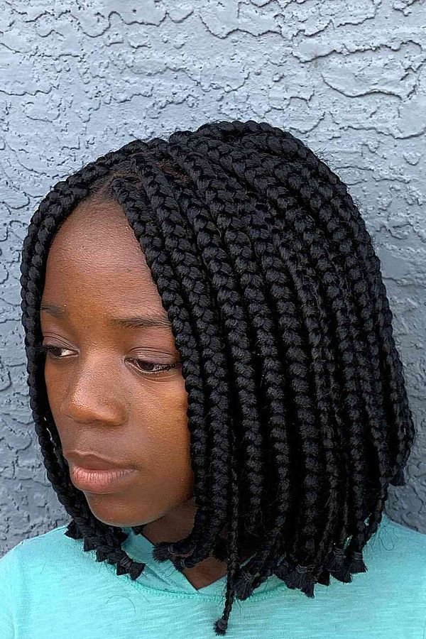 Short bob box braids with chunky plaits framing the face