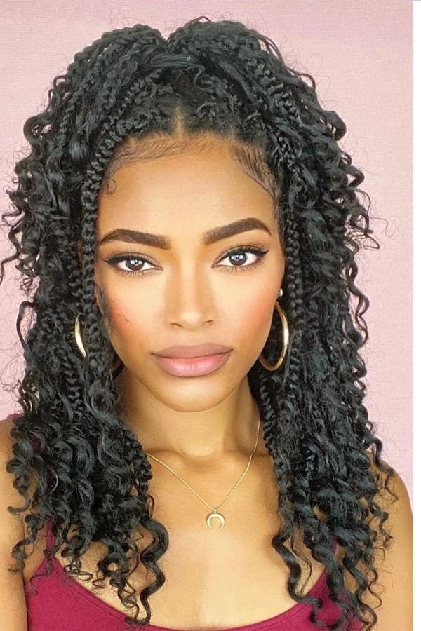Boho box braids with loose curly pieces woven through the braids