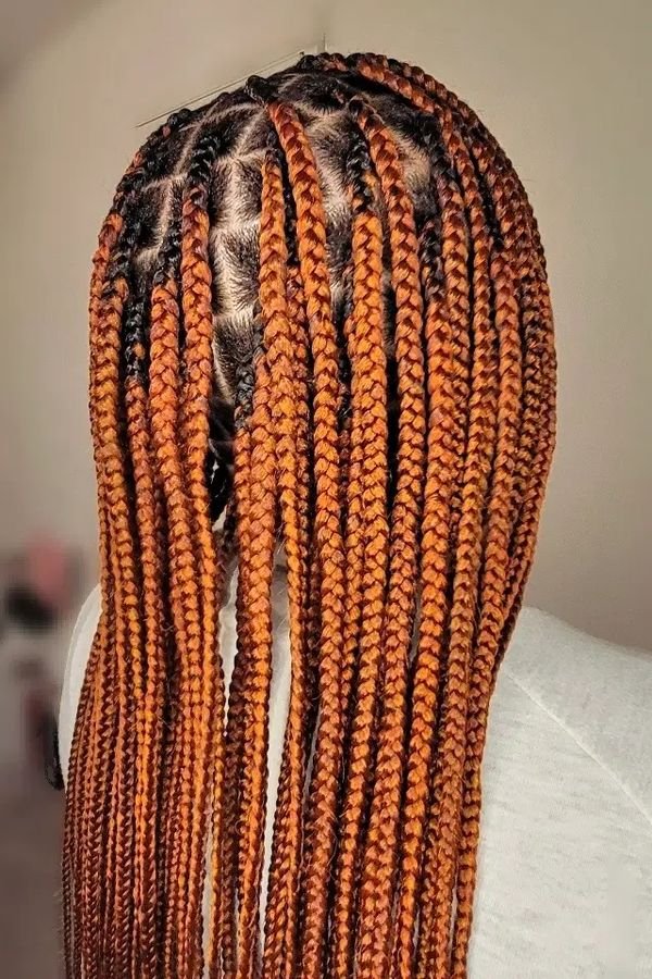 Ginger copper box braids seen from above, long plaits in a warm copper shade
