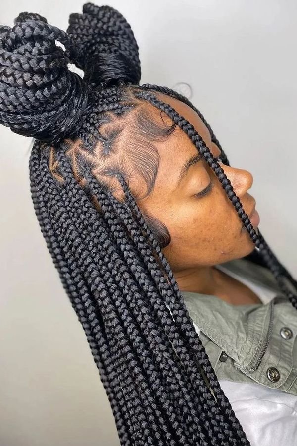 Half-up half-down box braids with a bow-shaped top bun