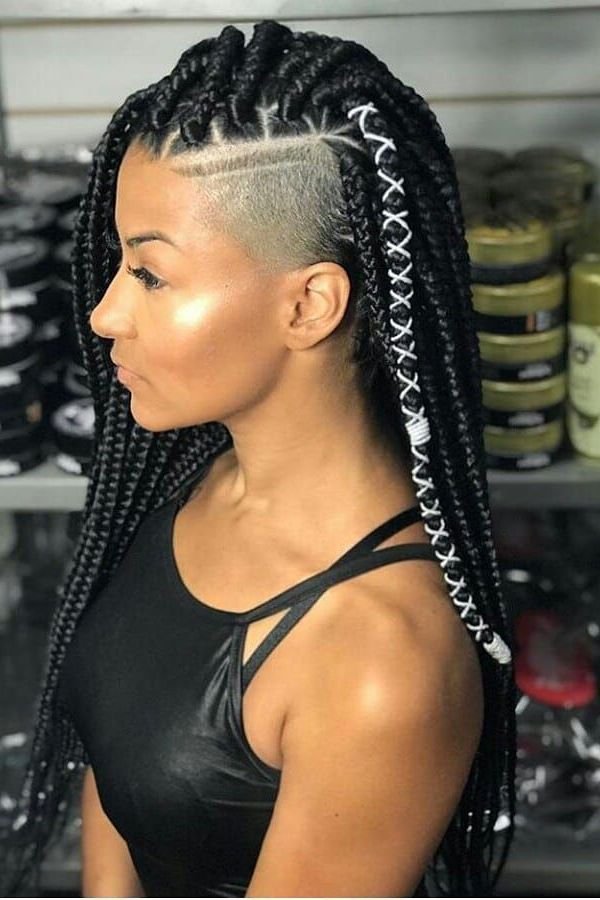Box braids with white thread wraps and a shaved side, profile view