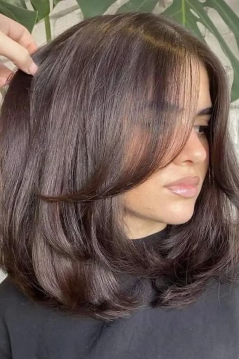 Butterfly bob haircut with layered movement at bob length