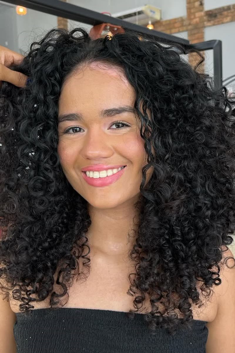Curly butterfly haircut with bouncy defined curls