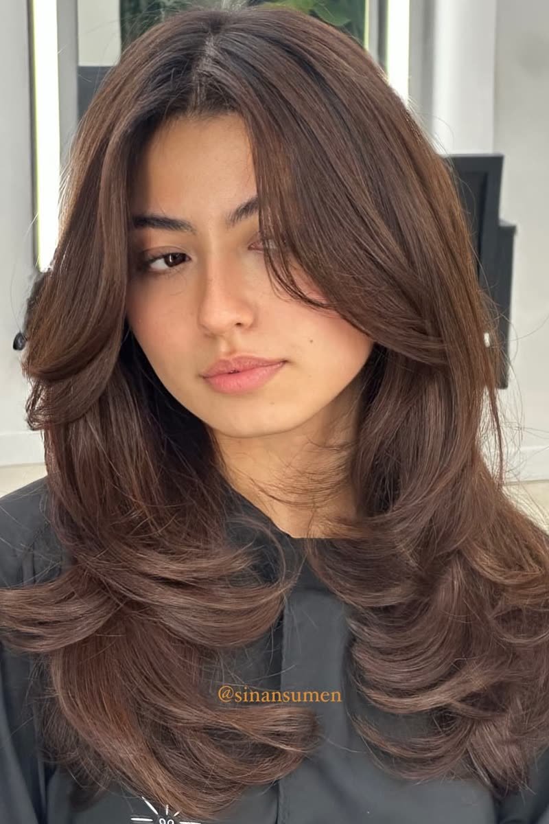 Layered butterfly haircut with maximum volume and bounce
