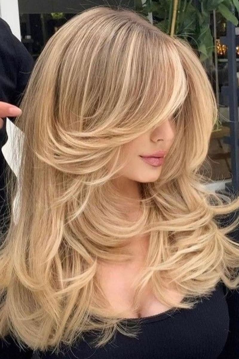 Golden blonde balayage butterfly haircut with sunlit dimension