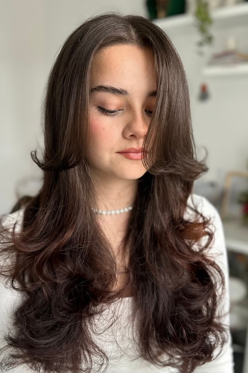 Butterfly haircut for a round face with slimming layers