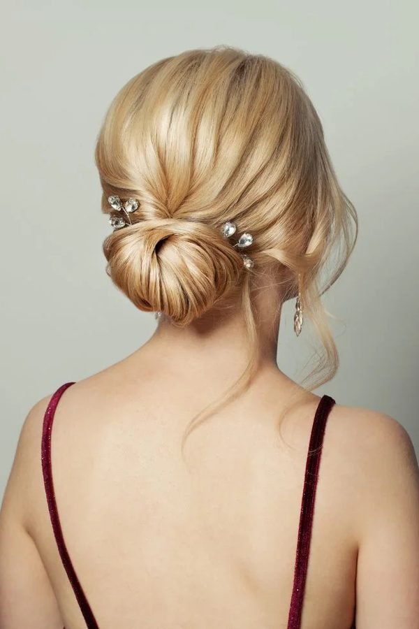 Low twisted bun with crystal gem hair pins, back view