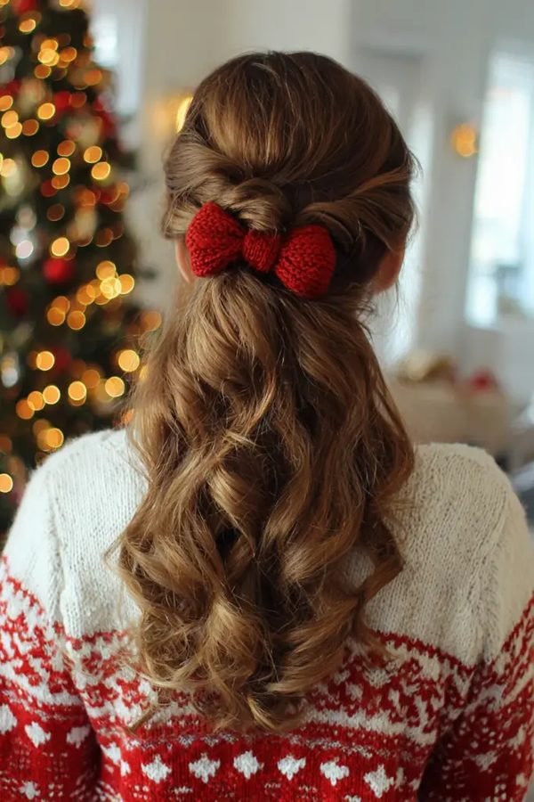 Twisted half-up hairstyle with a bow clip and loose curls