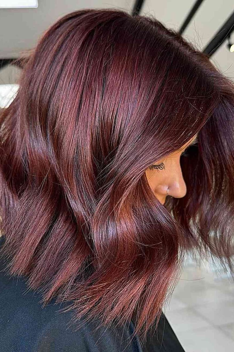 Subtle cherry shimmer on brunette lob