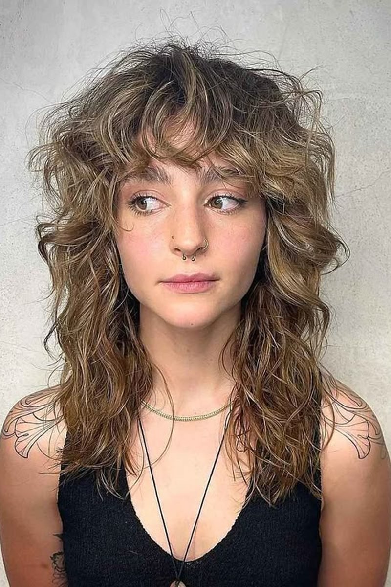 Wavy blonde wolf cut with curtain bangs, front view