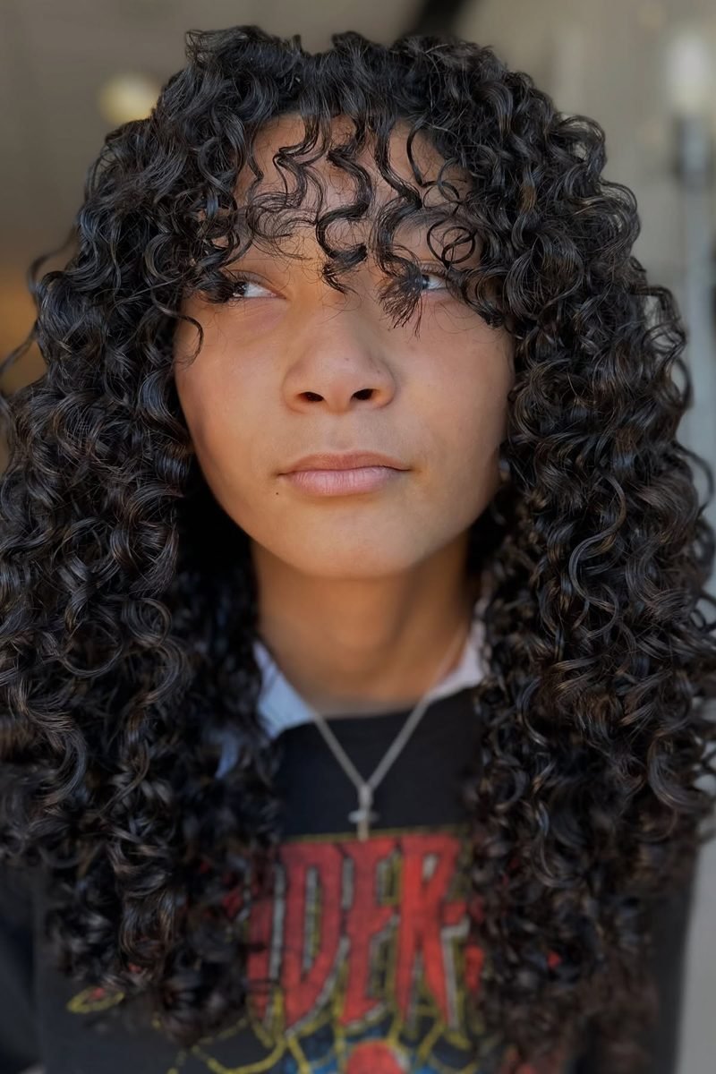 Tight ringlet curls in a voluminous curly wolf cut, close front view