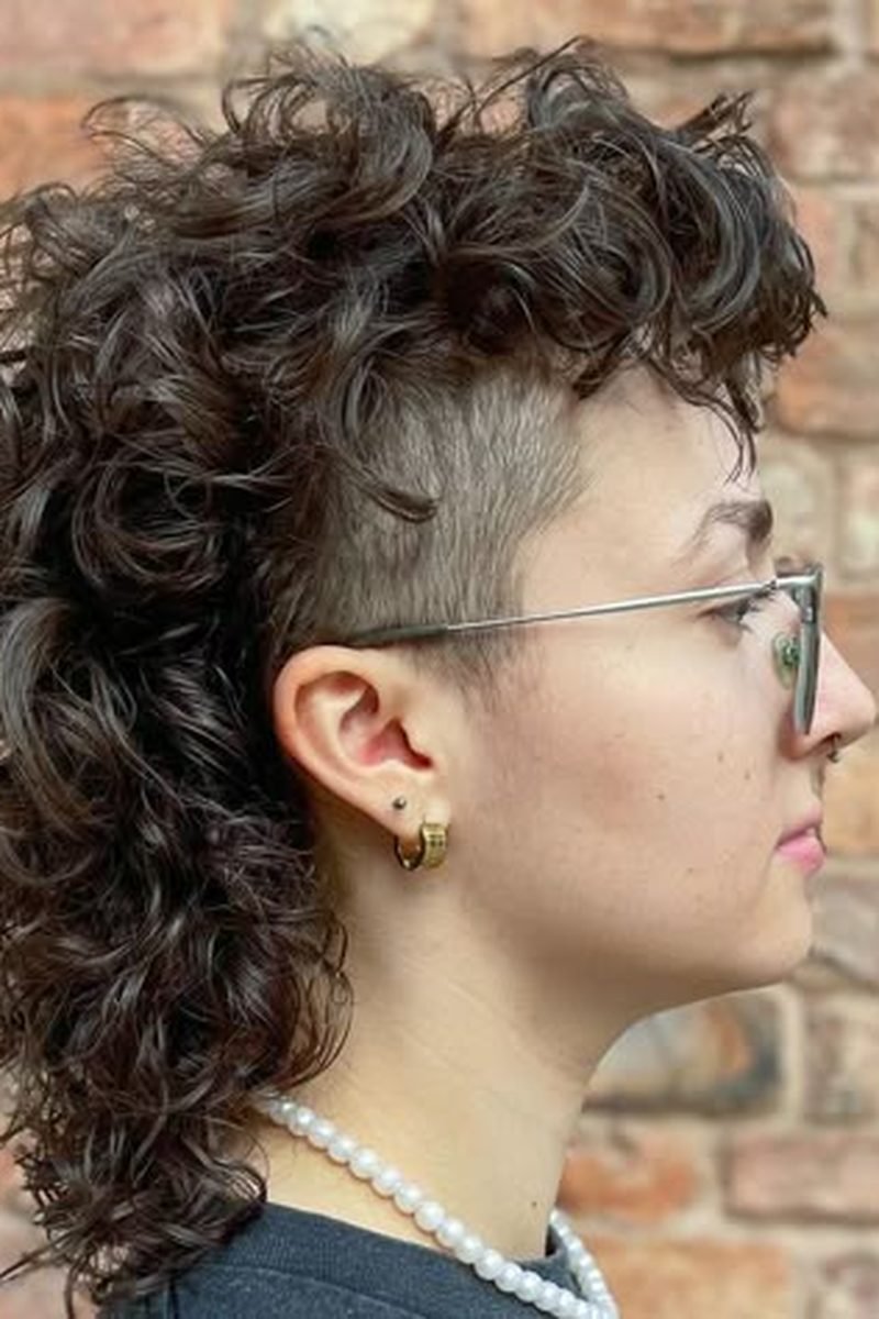 Curly wolf cut with shaved side detail, side profile outdoors