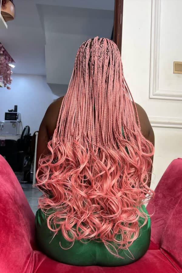 Back view of long bubblegum pink french curl braids with bouncy curly ends