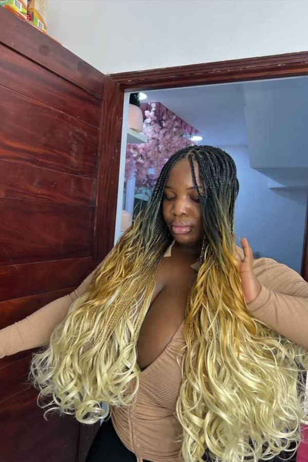 Front view of black-to-blonde ombre french curl braids