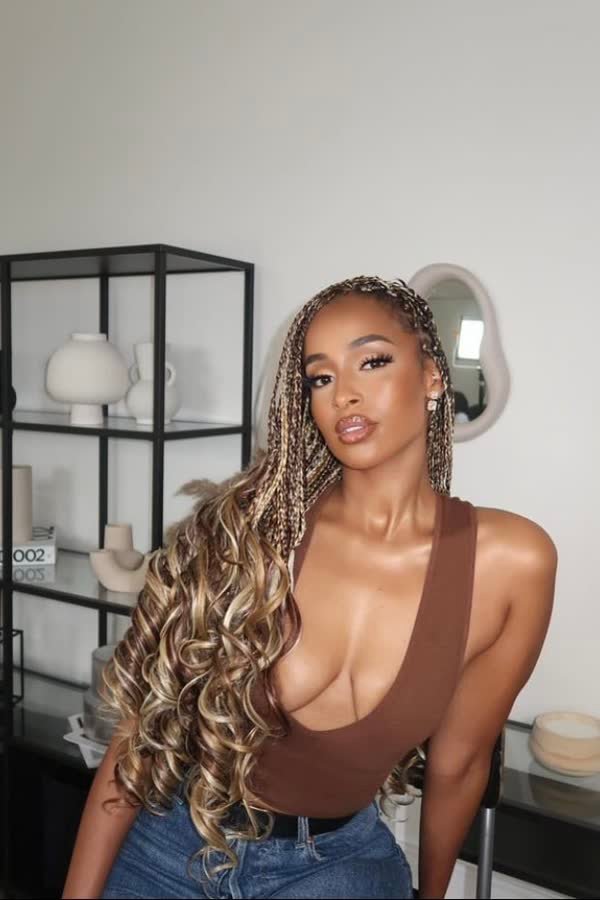 Three-quarter view of honey brown and blonde mixed french curl braids