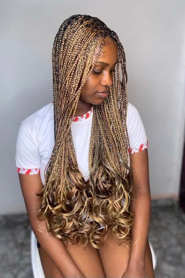 Three-quarter view of brown black and blonde tri-colour french curl braids