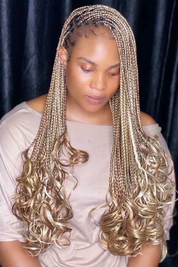 Front view of Fulani-inspired blonde mix french curl braids with cornrow details