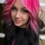 Dark hair with bold hot pink face-framing stripe panels, front view