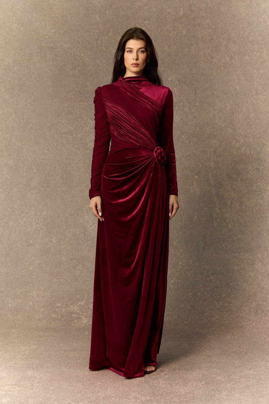 Woman in a glamorous burgundy velvet holiday gown, full-length portrait