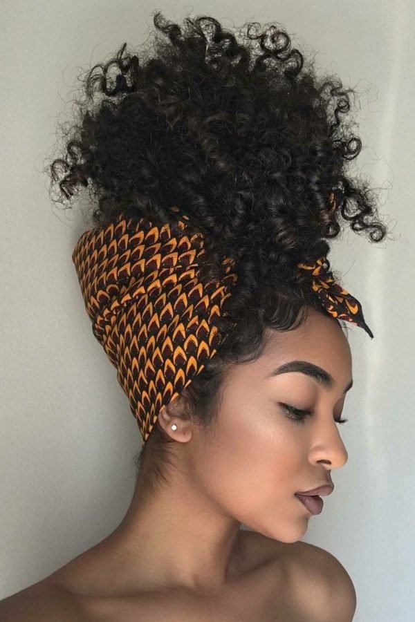 Pineapple puff hairstyle for natural curls with a patterned headwrap, side profile