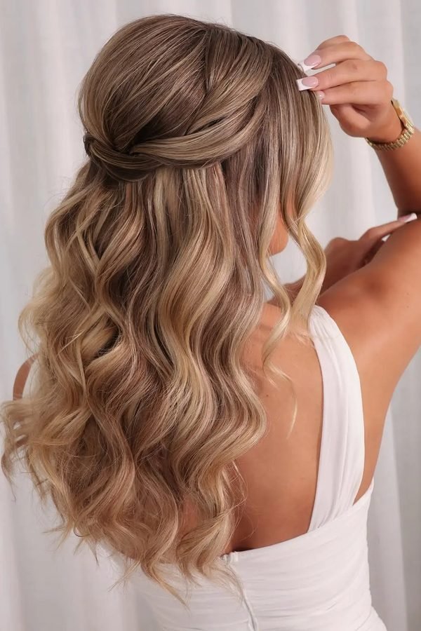 Loose waves half-up hairstyle with a wrapped crown section, back view
