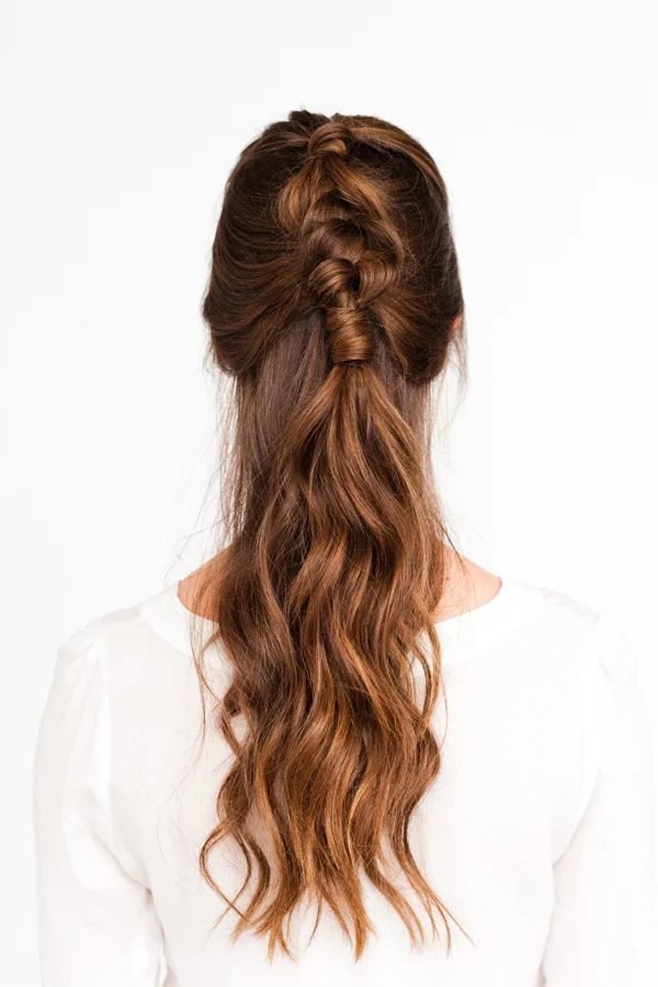 Braided half-up ponytail with auburn waves, back view