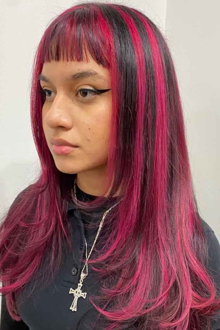 Dark hair with bold magenta-pink front panels and fringe, Y2K style